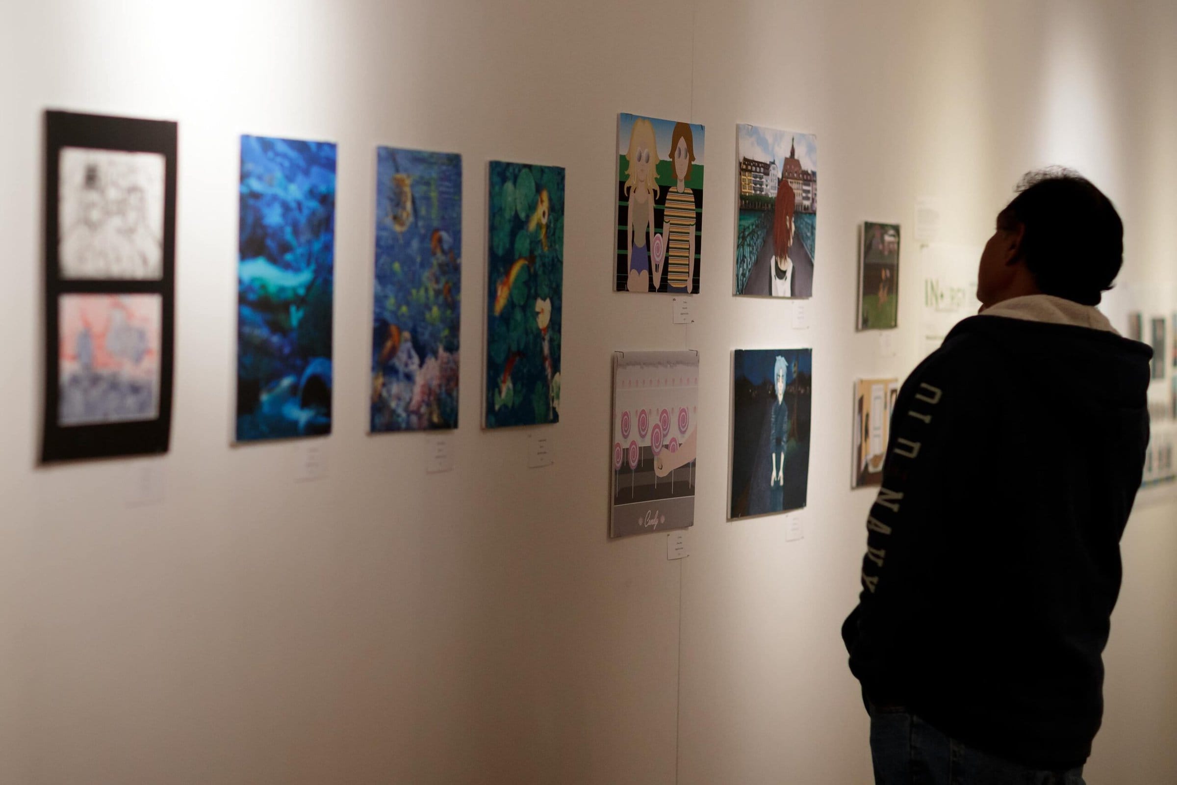 A person looks at student art at the High Museum