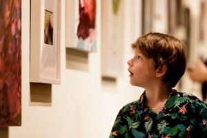 A young boy takes in some of the art on display during the President's Summer Art Series reception.