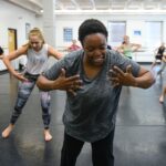 students dancing with hands open