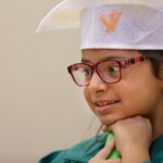 Child smiling in graduation gown