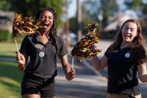 Two returning Brenau University students and orientation leaders cheer as first-year students move in to the Gainesville campus on Wednesday, Aug. 21. (AJ Reynolds/Brenau University)