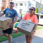 parents carrying boxes