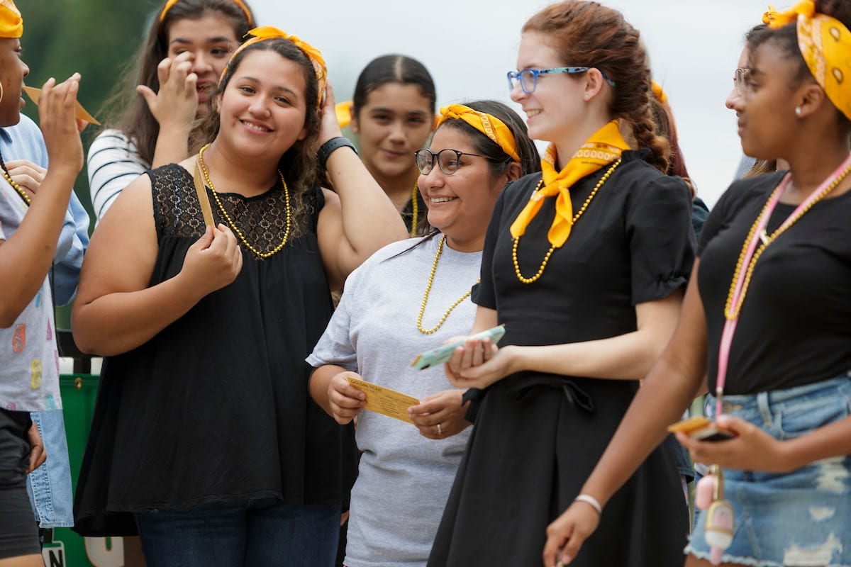 Students with their golden necklaces and tickets.