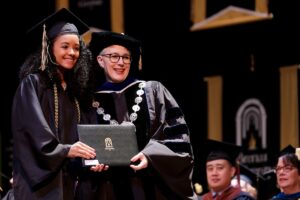 student recives diploma from the president