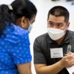 A student in Brenau's OT program helps out at the Caregiver Assistance and Resource Event (CARE) Fair.