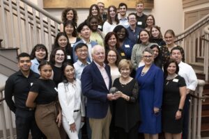 A group poses for a photo at the launch of the Miller Institute