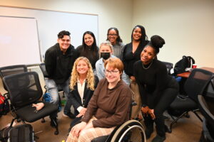 Occupational therapy, fashion design students and their client in her new outfit.