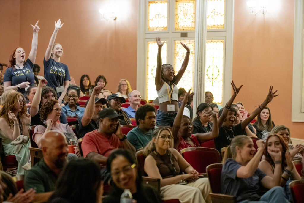 Students get excited during an assembly in Pearce Auditorium at summer orientation