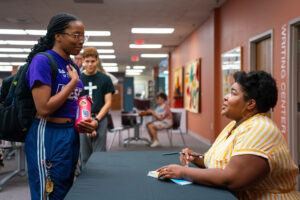 Dulce Sloan signs a book for a Brenau student