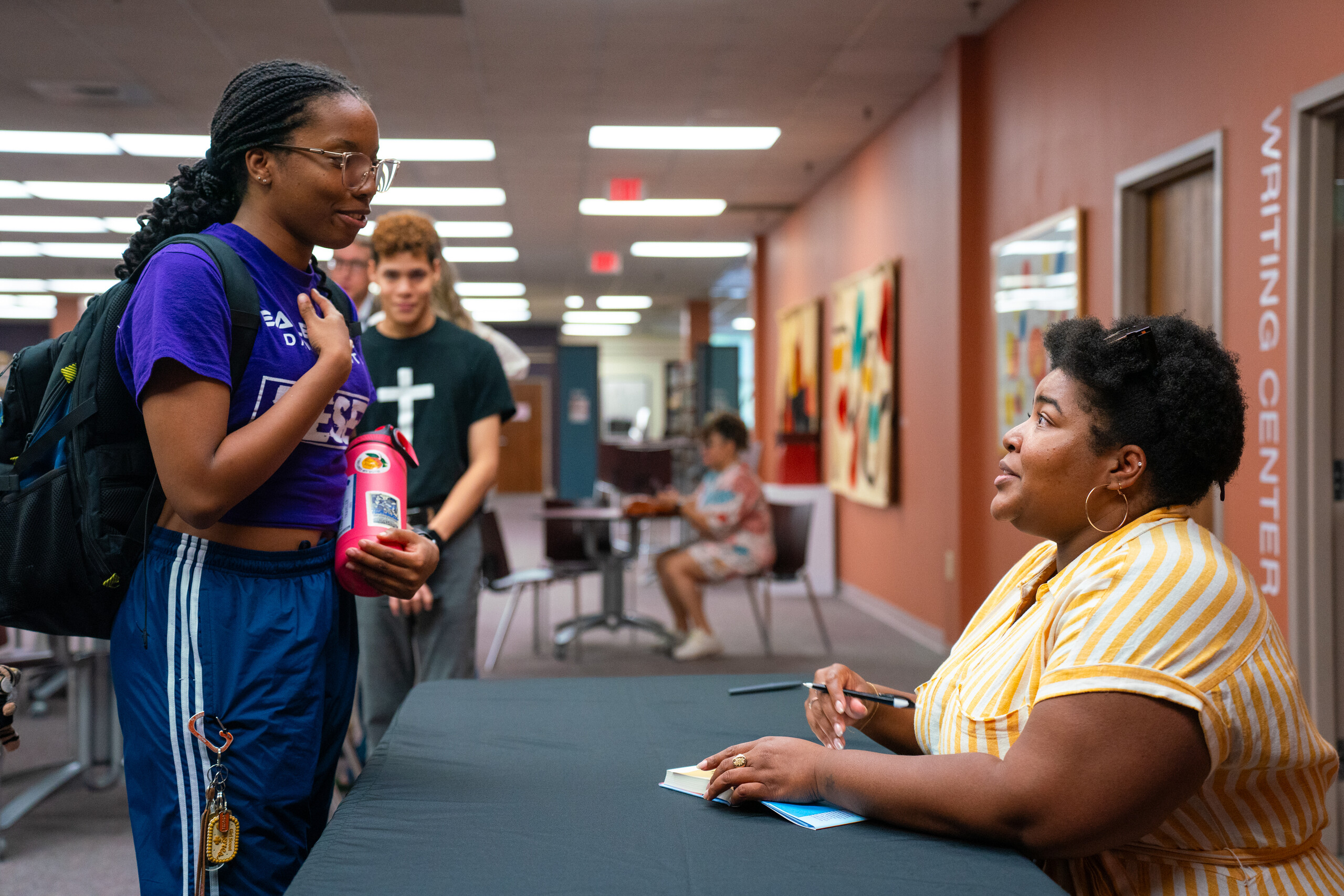 Dulce Sloan signs a book for a Brenau student