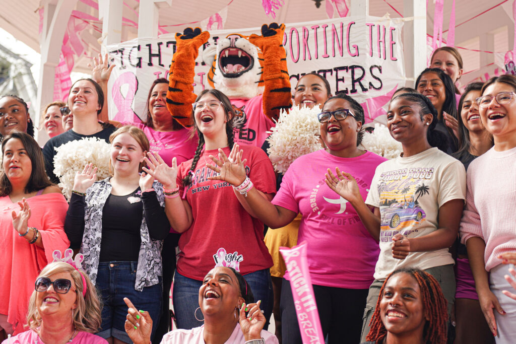 Students, faculty and staff pose for a group photo before the annual pink out with HJ