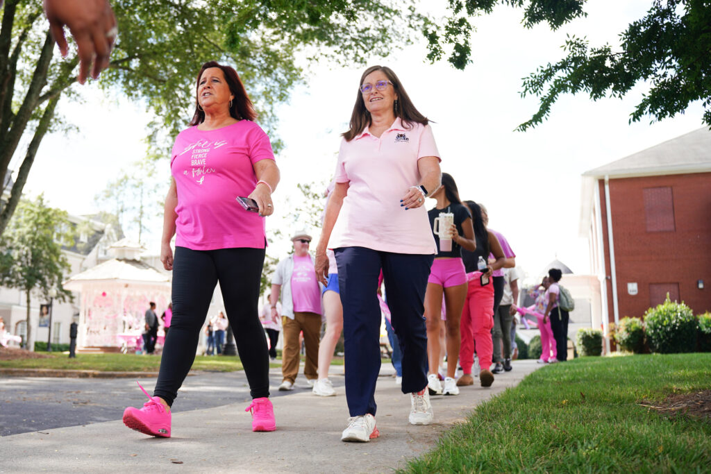 College of Education faculty walk during the pink out