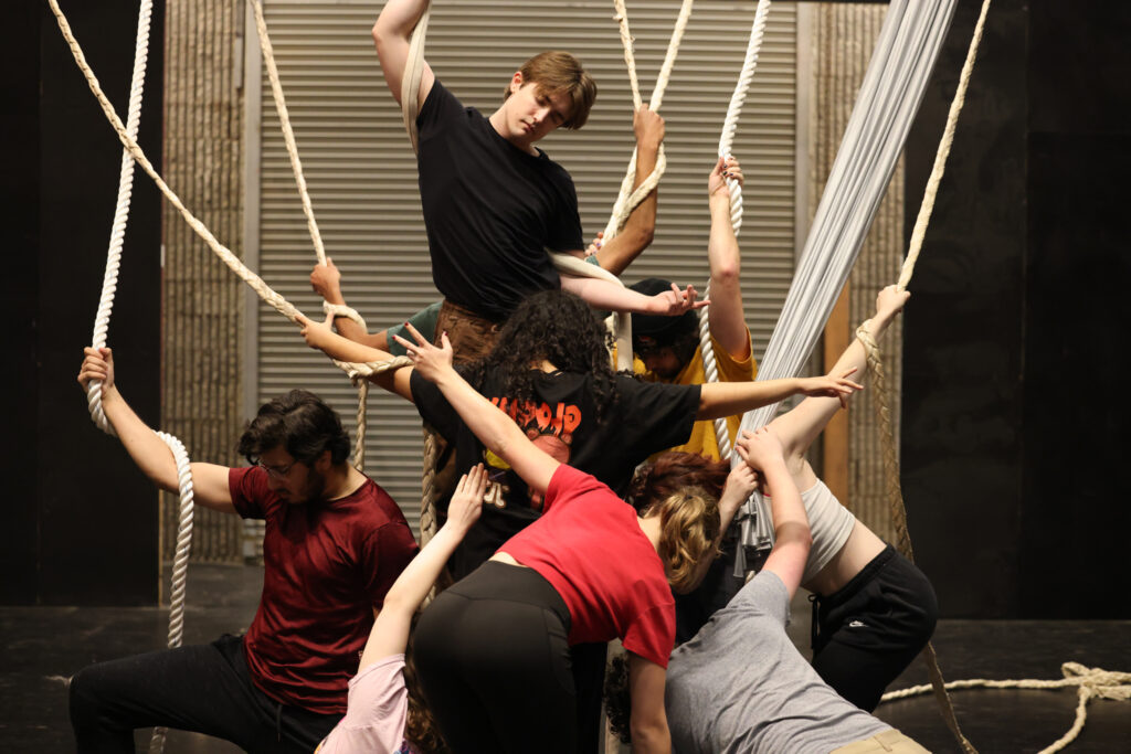 Students rehearse using the aerial ropes and silk during A Monster Calls rehearsal.