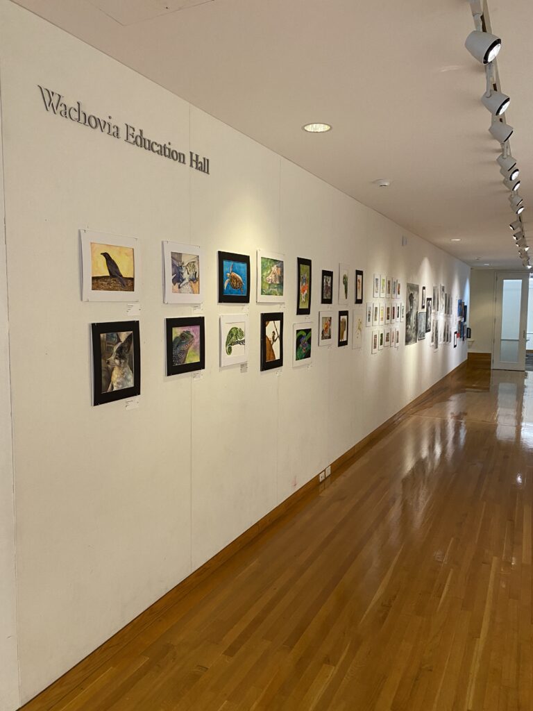 paintings on a white wall in the Wachovia Education Hall