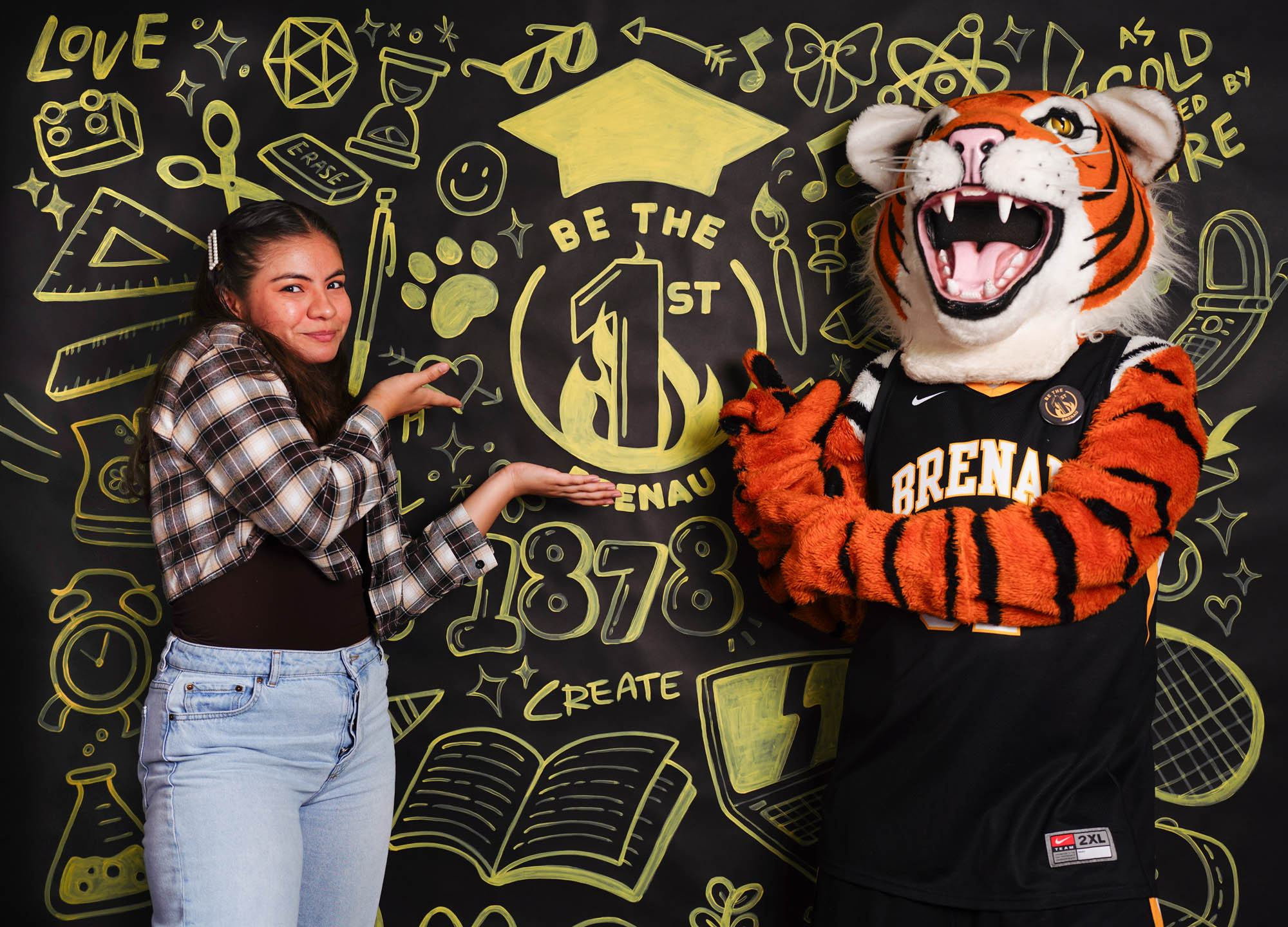 Student and Mascot Posing in front of a back drop